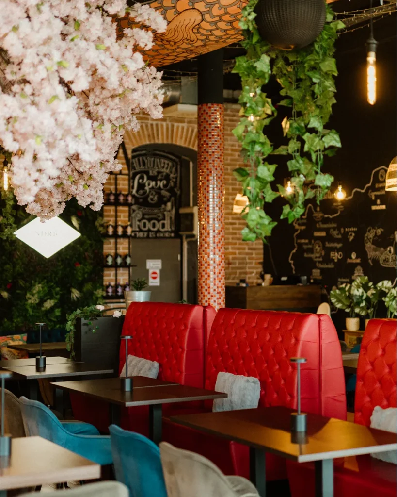 Warm interior atmosphere with blossom decor and red seating, inviting dining mood