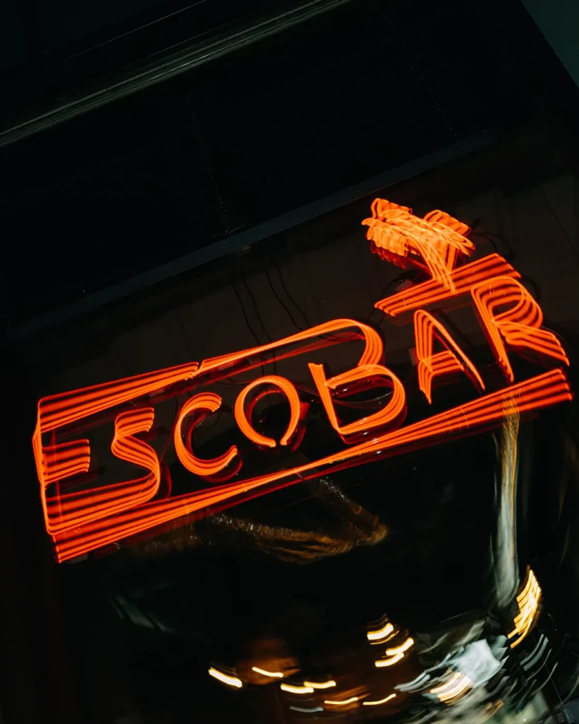 se-up of an illuminated Escobar sign in the dark, bold nightlife branding