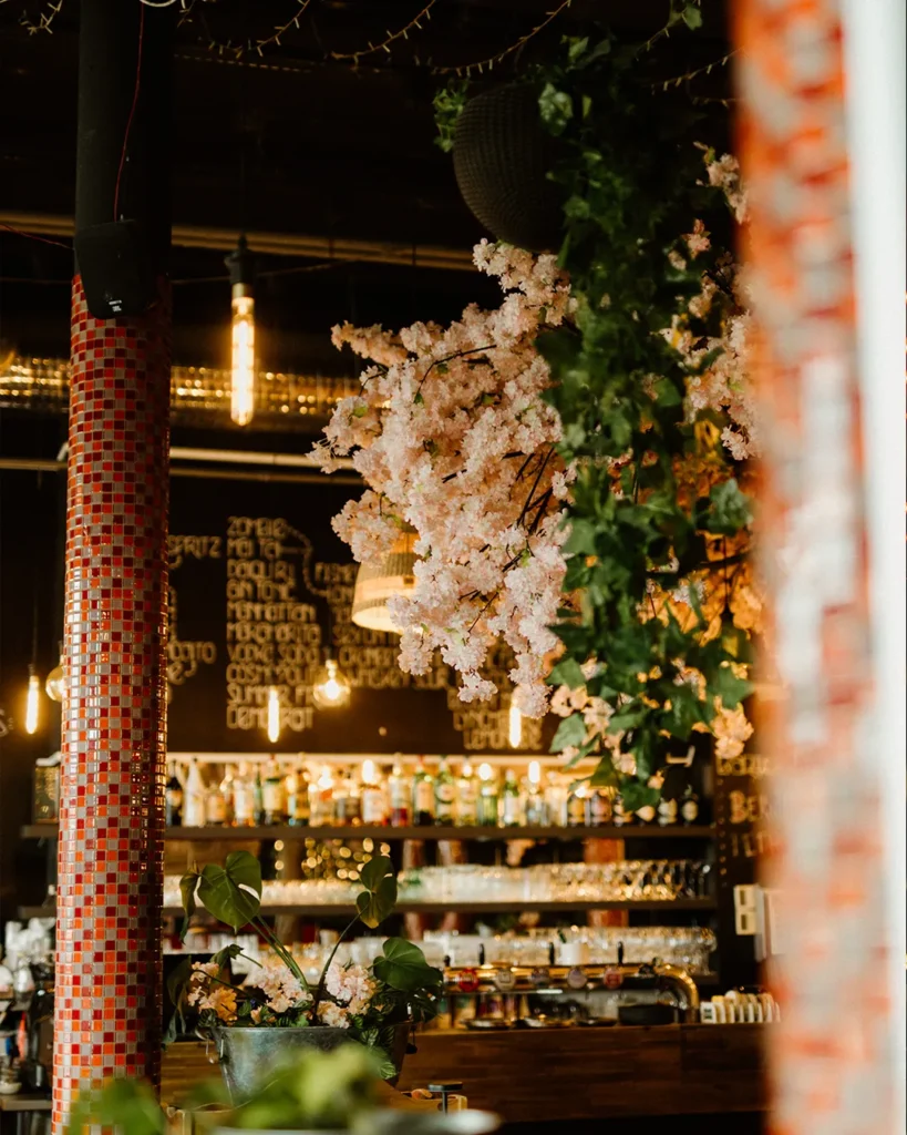 Bar shelf detail with bottles and warm lighting, intimate evening ambience