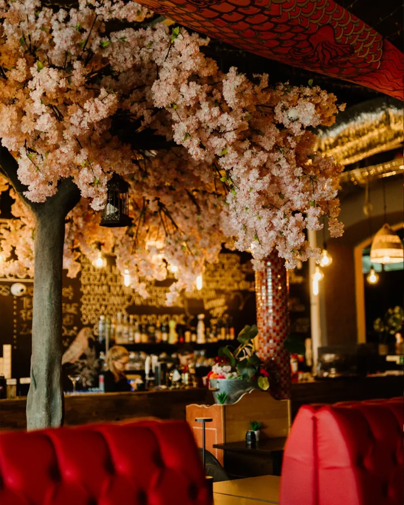 Red booth seating inside the venue with warm lighting and decorative elements