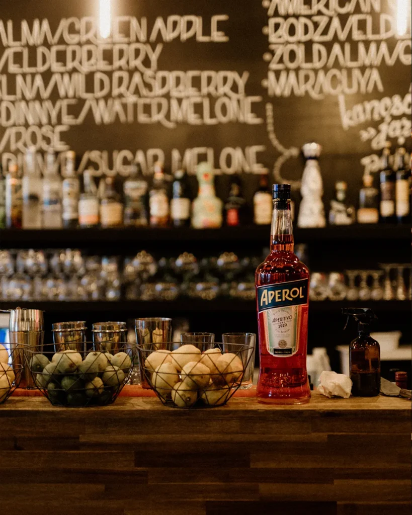 Bar display with bottles and textured backdrop, cinematic low-light atmosphere
