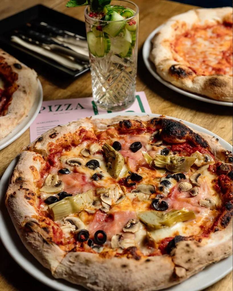 Close-up pizza on a table in warm lighting, casual dining mood