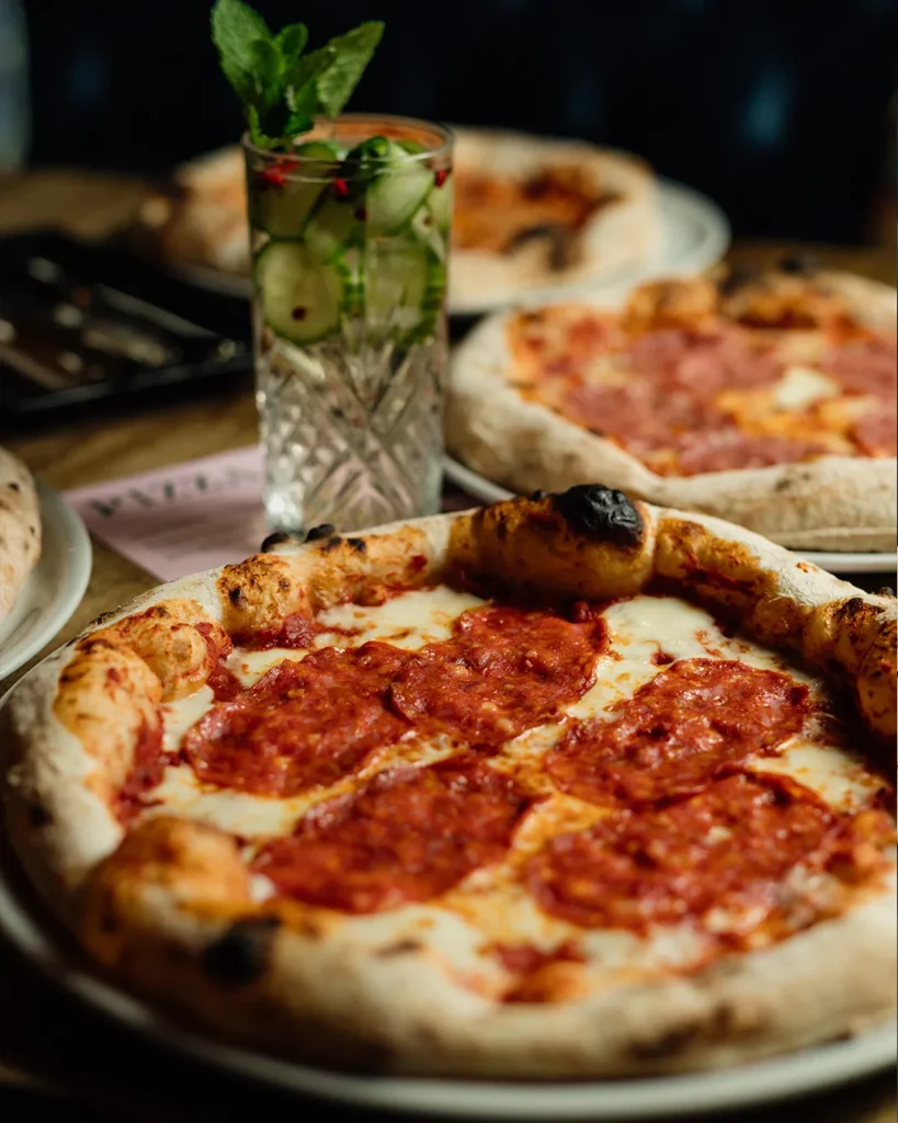 Pizza photographed from above on a table, clean composition for menu layout