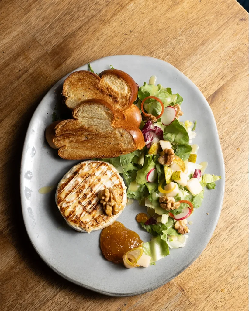 Neatly plated small dish with garnish, minimal composition for menu visuals